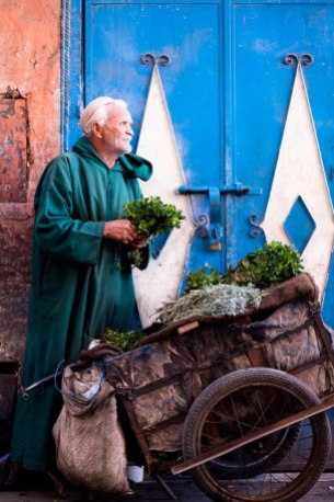 A Moroccan man selling herbs in the street.